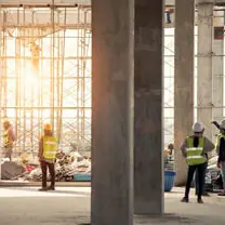A frame going up, and the crew standing inside it.