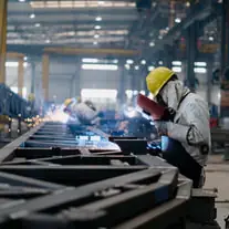 A welder at the line, on a fabrication floor.