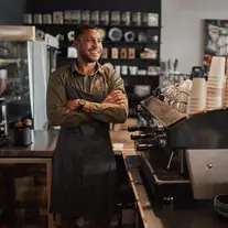 A café owner behind his own counter.