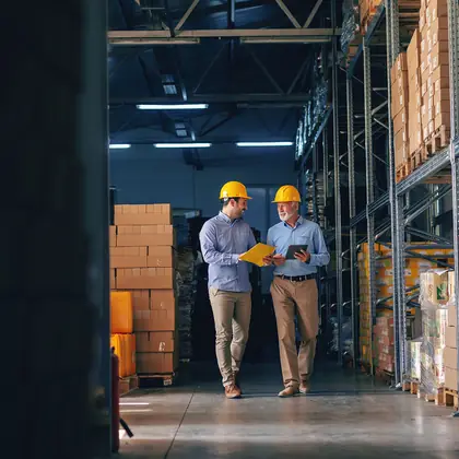 Two owners walking their own stockroom aisle.